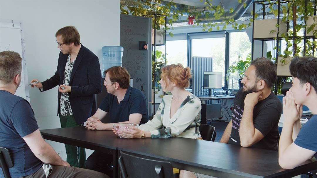 RandomForest team members discussing work around a table